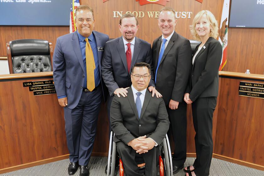 Orange County Board of Education trustees pose Tuesday with newly appointed Supt. Dr. Stefan Bean.