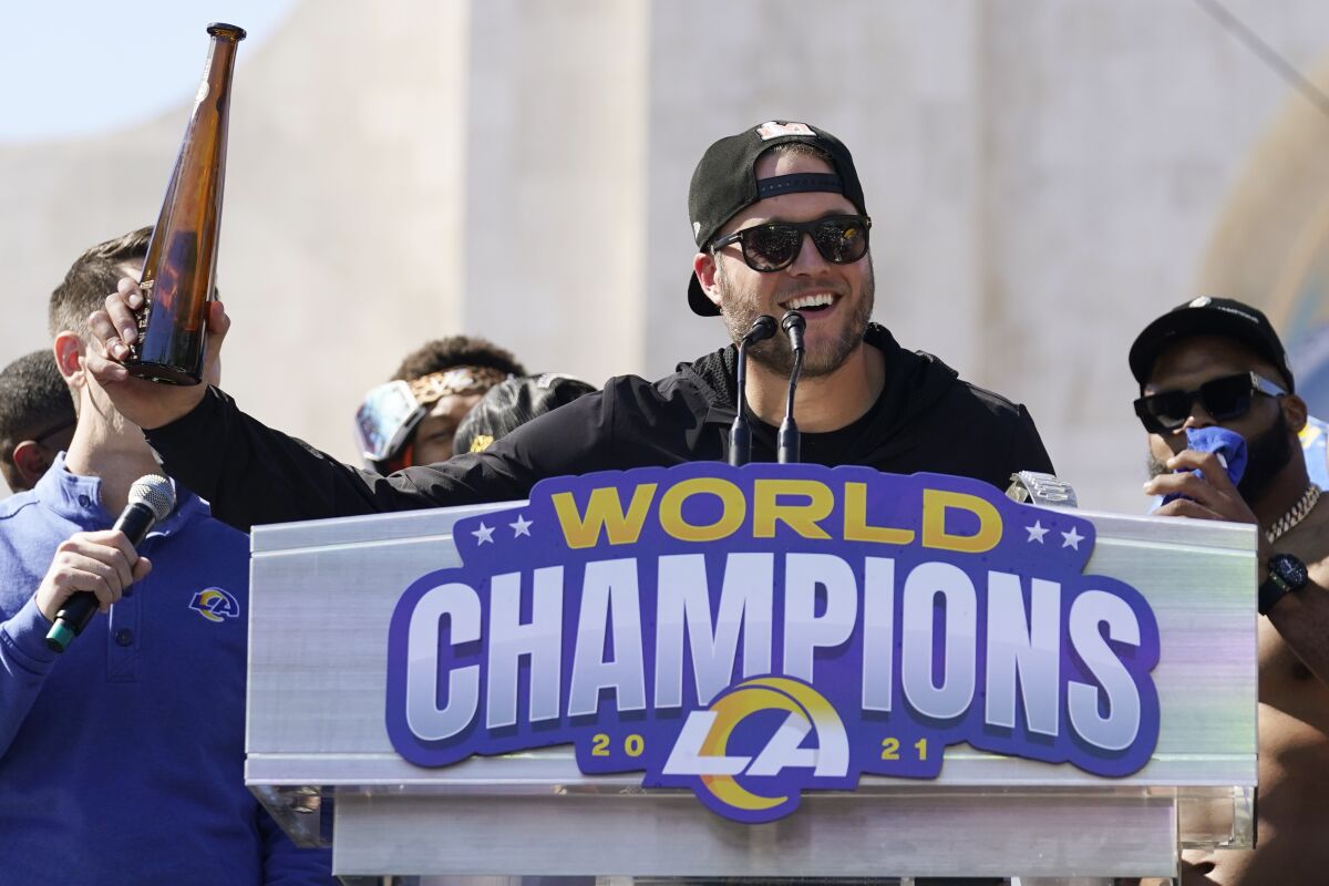 Los Angeles Rams quarterback Matthew Stafford holds up a bottle during the team's victory celebration and parade in Los Angeles, Wednesday, Feb. 16, 2022, following the Rams' win Sunday over the Cincinnati Bengals in the NFL Super Bowl 56 football game. (AP Photo/Marcio Jose Sanchez)