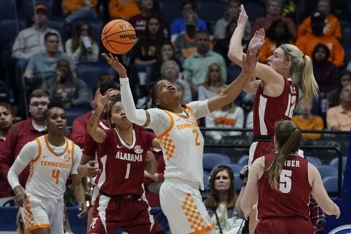 Tennessee's Alexus Dye (2) battles for the ball with Alabama's Megan Abrams (1) and Allie Craig Cruce (12) in the first half of an NCAA college basketball game at the women's Southeastern Conference tournament Friday, March 4, 2022, in Nashville, Tenn. (AP Photo/Mark Humphrey)