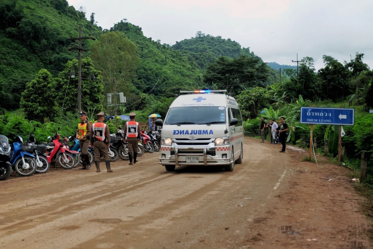 An ambulance leaves the scene near Tham Luang Nang Non cave in the early hours on July 9, 2018 in Chiang Rai, Thailand. Divers began an effort to pull the 12 boys and their soccer coach on Sunday morning after they were found alive in the cave at northern Thailand.