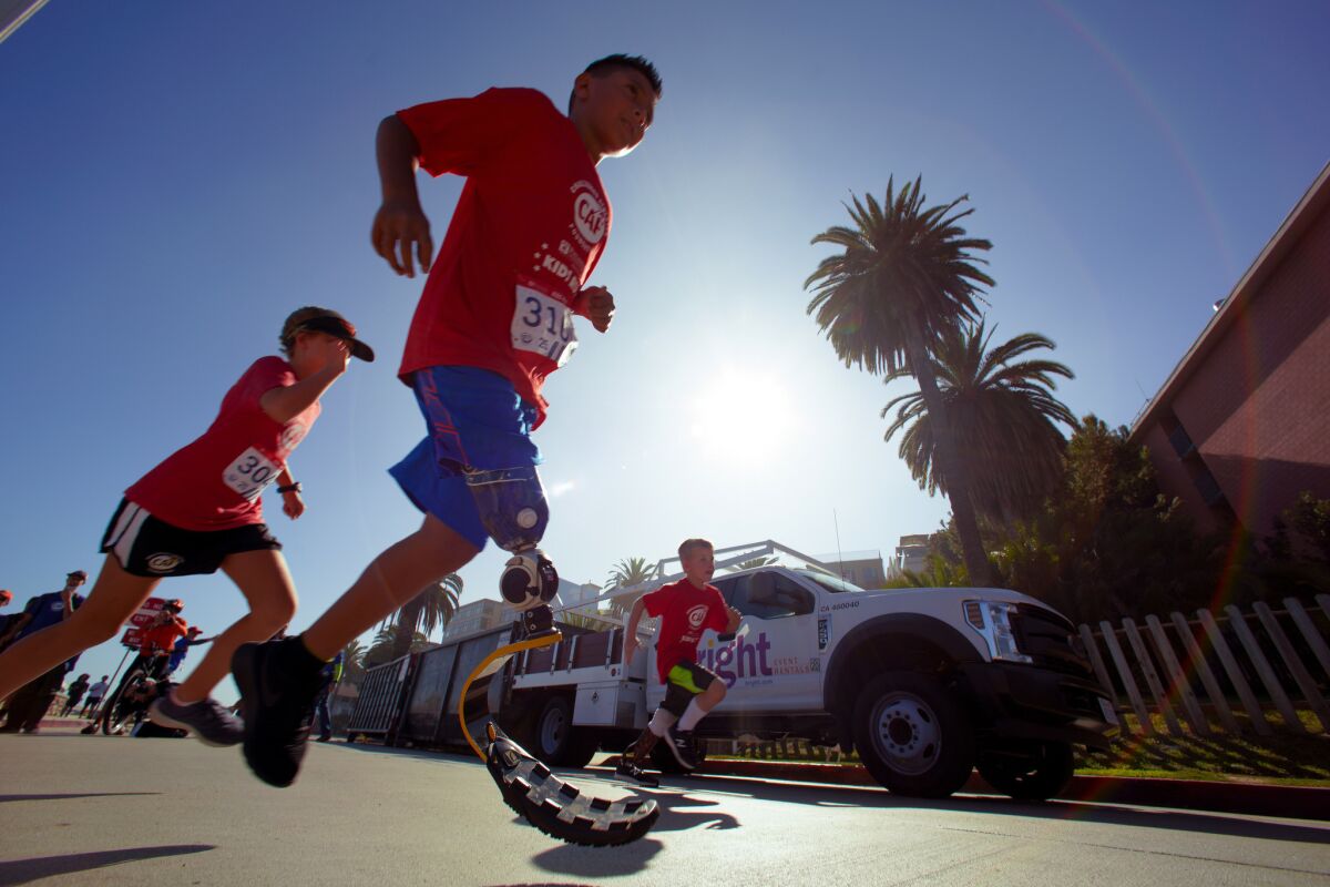 Young children make the first turn on the course during Sunday’s Challenged Athlete Foundation, Kids Run at La Jolla Cove.