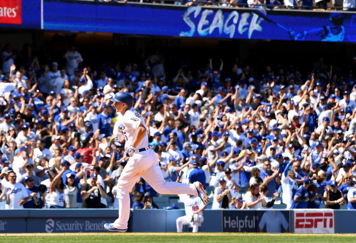 Dodgers shortstop Corey Seager hits a solo home run off Diamondbacks pitcher Zack Greinke (not pictured) during the fourth inning of the Dodgers' 12-5 win Thursday.