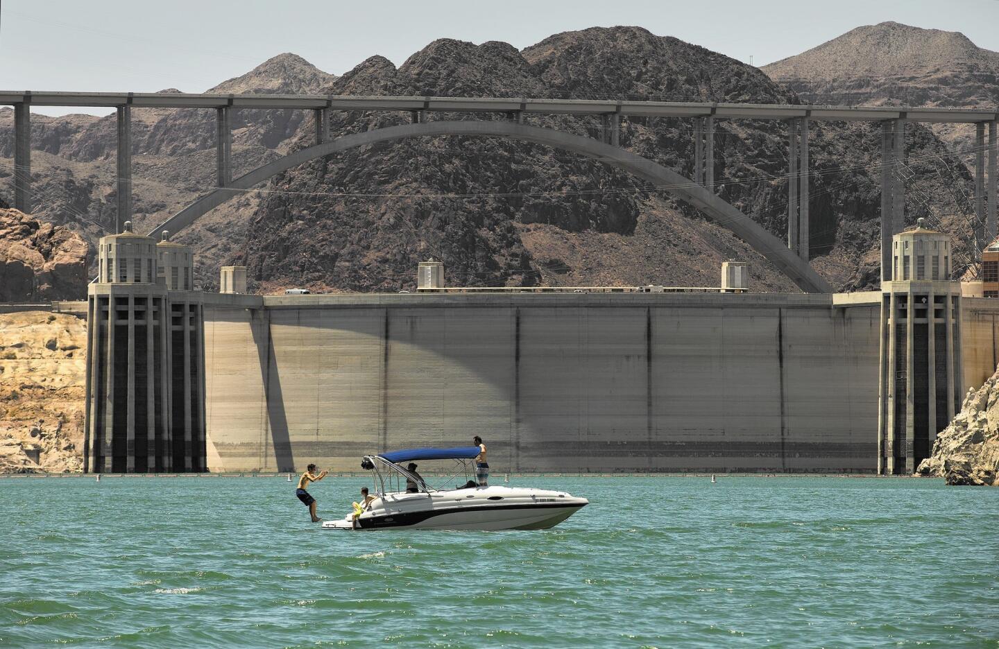 Lake Mead, created by the Hoover Dam, entices boaters to take a plunge on a July day. The reservoir doubles as a recreation area.