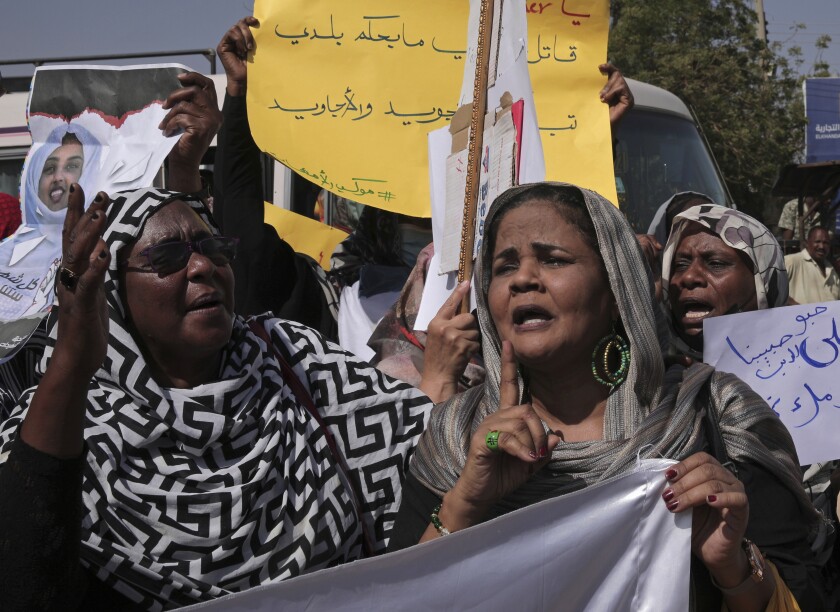 Women chant slogans against the killing of demonstrators in street protests triggered by an October military coup, in the twin city of Omdurman, about 18 miles (30 km) northwest of the capital Khartoum, Sudan, Tuesday, Jan. 11, 2022. The fall coup triggered relentless street protests and over 60 protesters have since been killed as security forces cracked down on demonstrations. (AP Photo/Marwan Ali)
