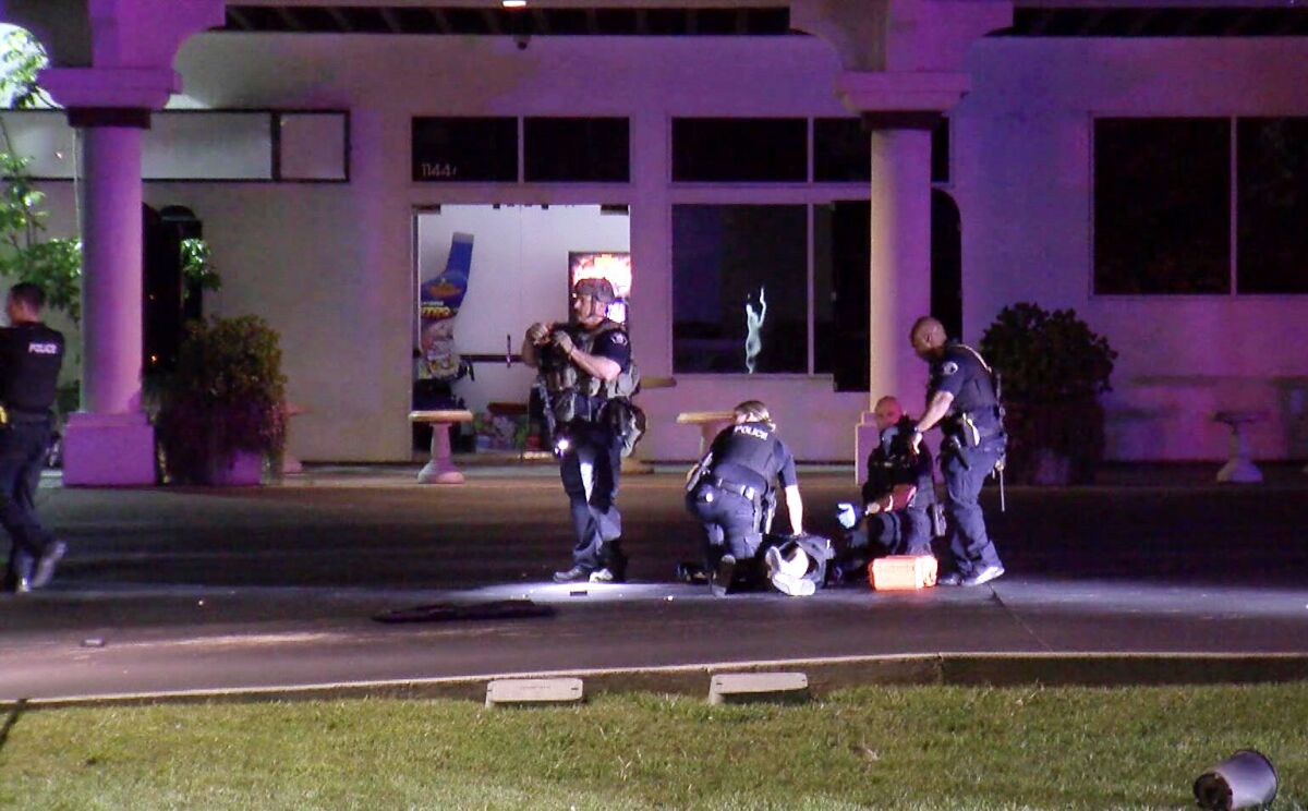Four police officers standing in front of a building