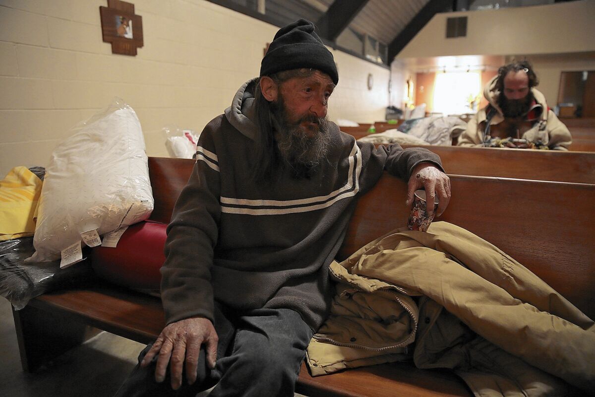 Dale Meyer, 58, settles in for a night at All Saints' Episcopal Church in Highland Park. Meyer said he was born and raised in Highland Park and ended up homeless years ago after he was laid off from a print shop.