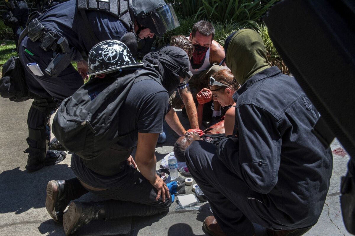 A victim is attended to after he was stabbed during a violent confrontation between members of a neo-Nazi rally and counter-protesters at the state Capitol in Sacramento last summer.
