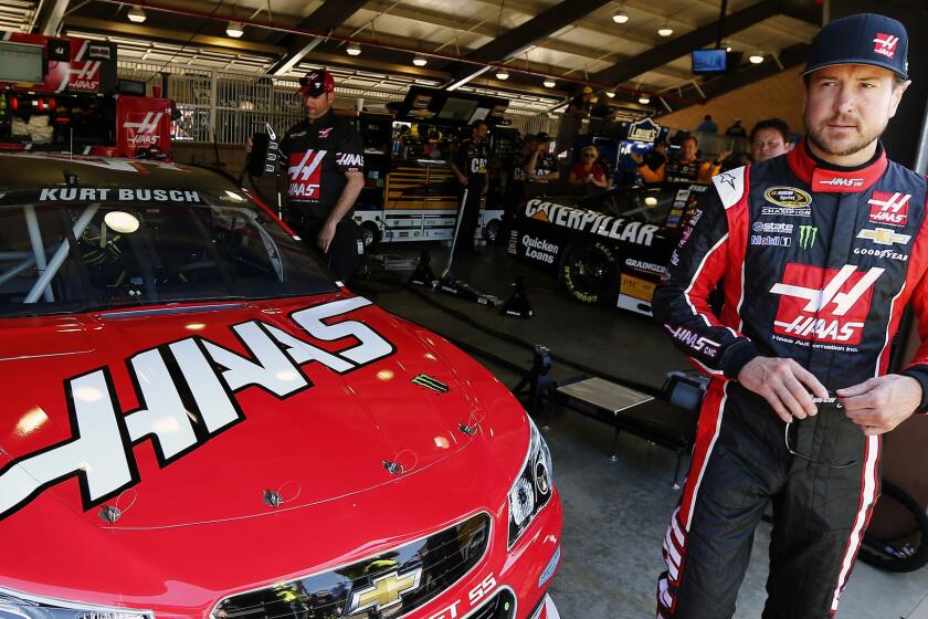Kurt Busch stands in front of his car during NASCAR Sprint Cup Series practice at Auto Club Speedway in Fontana on Friday.