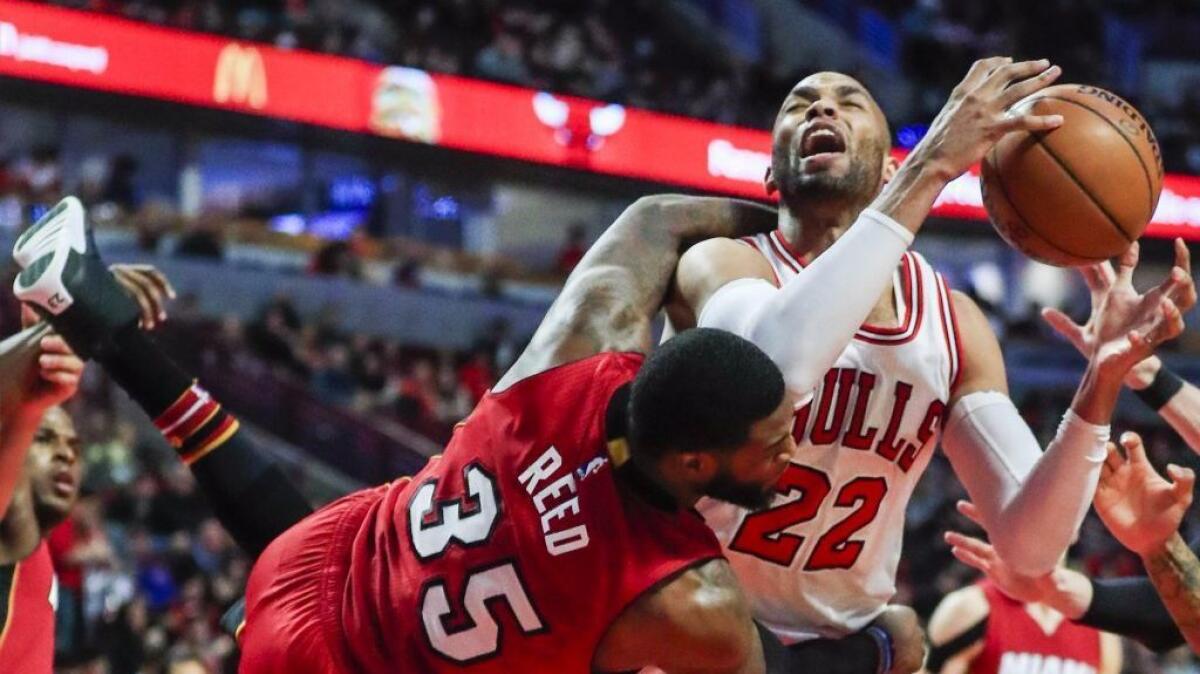 Bulls forward Taj Gibson is fouled by Heat forward Willie Reed during the second half of a game in Chicago on Jan. 27.