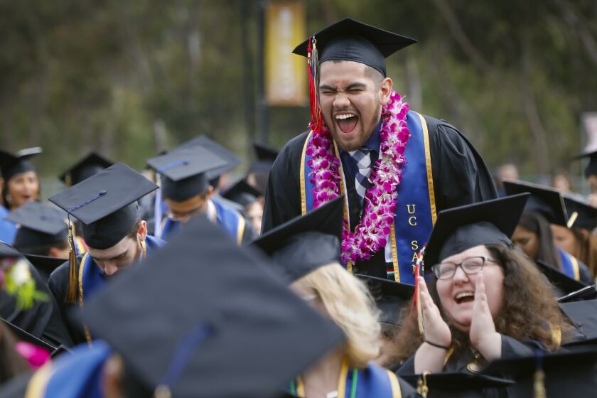 UC San Diego ethnic studies major, David Rodriguez, yells his appreciation as his class is called during the all campus commencement ceremony at RIMAC Field.