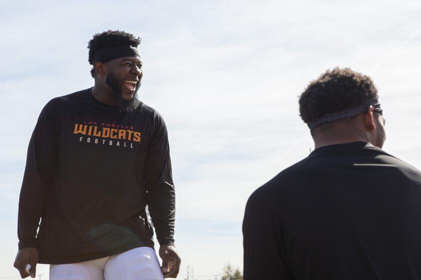 LOS ANGELES, California-FEBRUARY 5, 2020: Tre' Williams, a Linebacker for the Los Angeles Wildcats, jokes around with his teammates before practice at Veteran's Memorial Stadium at Long Beach City College. (Gabriella Angotti-Jones/Los Angeles Times)