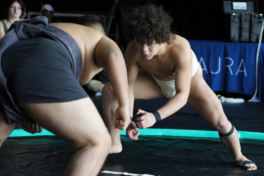 San Diego, CA - February 24: At the City Heights Performance Annex on Saturday, Feb. 24, 2024 in San Diego, CA, Jio Talbert takes on his opponent wrestler in the 2nd Annual SoCal Sumo Open. (Nelvin C. Cepeda / The San Diego Union-Tribune)