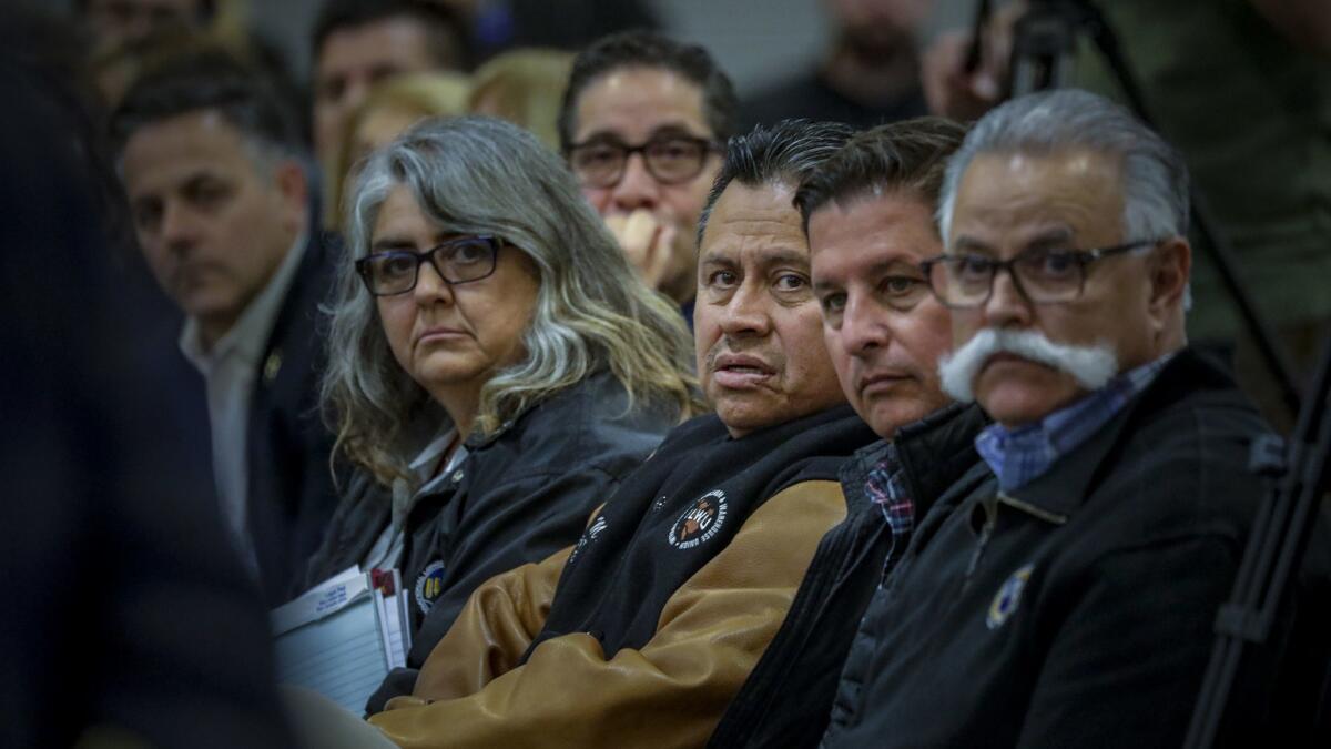 Union President Mark Mendoza, center, spoke at a Harbor Commission hearing over whether to allow APM to use driverless electric cargo vehicles.
