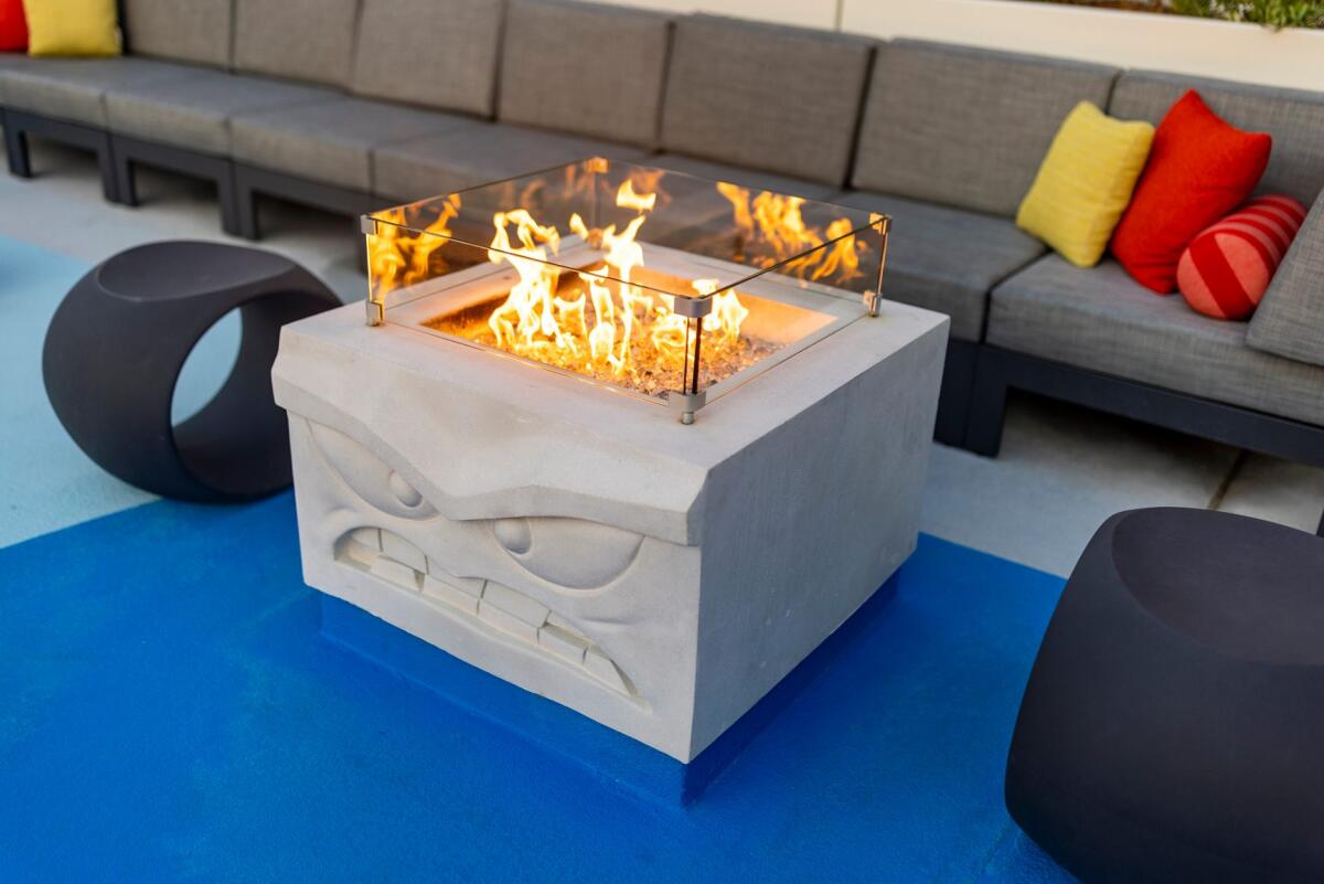 A fire pit in which fire is rising from the head of the character of Anger.