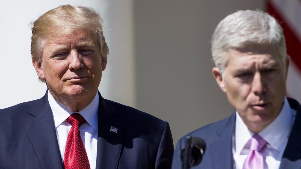 Supreme Court Justice Judge Neil Gorsuch speaks as President Trump looks on during a ceremony at the White House on April 10.