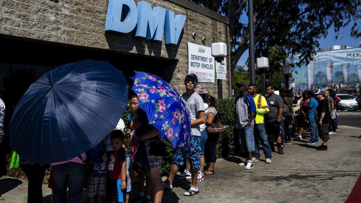 A line of people stretches around the South L.A. location of a California Department of Motor Vehicles office on Aug. 7.