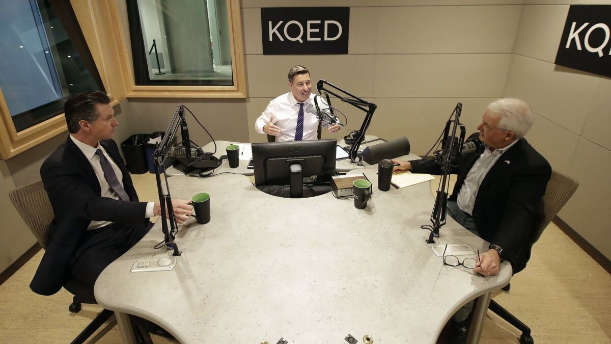 Radio host Scott Shafer, center, speaks before moderating a California gubernatorial debate between Democratic candidate Gavin Newsom, left, and Republican candidate John Cox at KQED's studio in San Francisco on Monday.