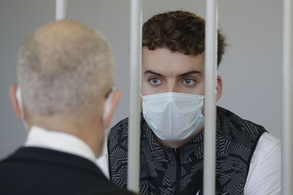 Gabriel Natale-Hjorth wears a face mask to curb the spread of COVID-19 as he sits inside a cell in the courtroom before a jury began deliberating his fate and that of his co-defendant Finnegan Lee Elder in their trial accused of the slaying of an Italian plainclothes police officer on a street near the hotel where they were staying while on vacation in Rome in summer 2019, in Rome on May 5, 2021. Lawyers and family of two young American men convicted of murdering a police officer in Rome said they are hoping for a better outcome in the defendants' appeals trial, which began on Thursday in the Italian capital. (AP Photo/Gregorio Borgia, File)