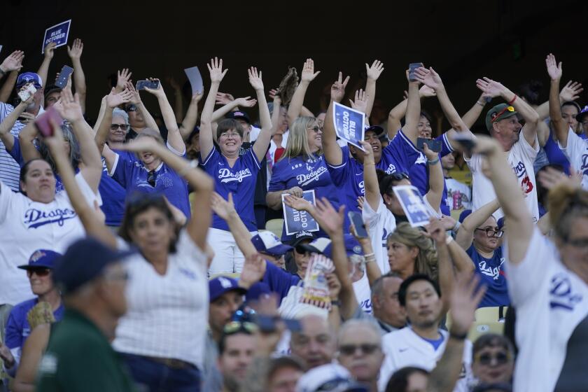 Los Angeles Dodgers fans cheer during a simulated baseball game ahead of the NLDS in Los Angeles, Wednesday, Oct. 4, 2023. (AP Photo/Ashley Landis)