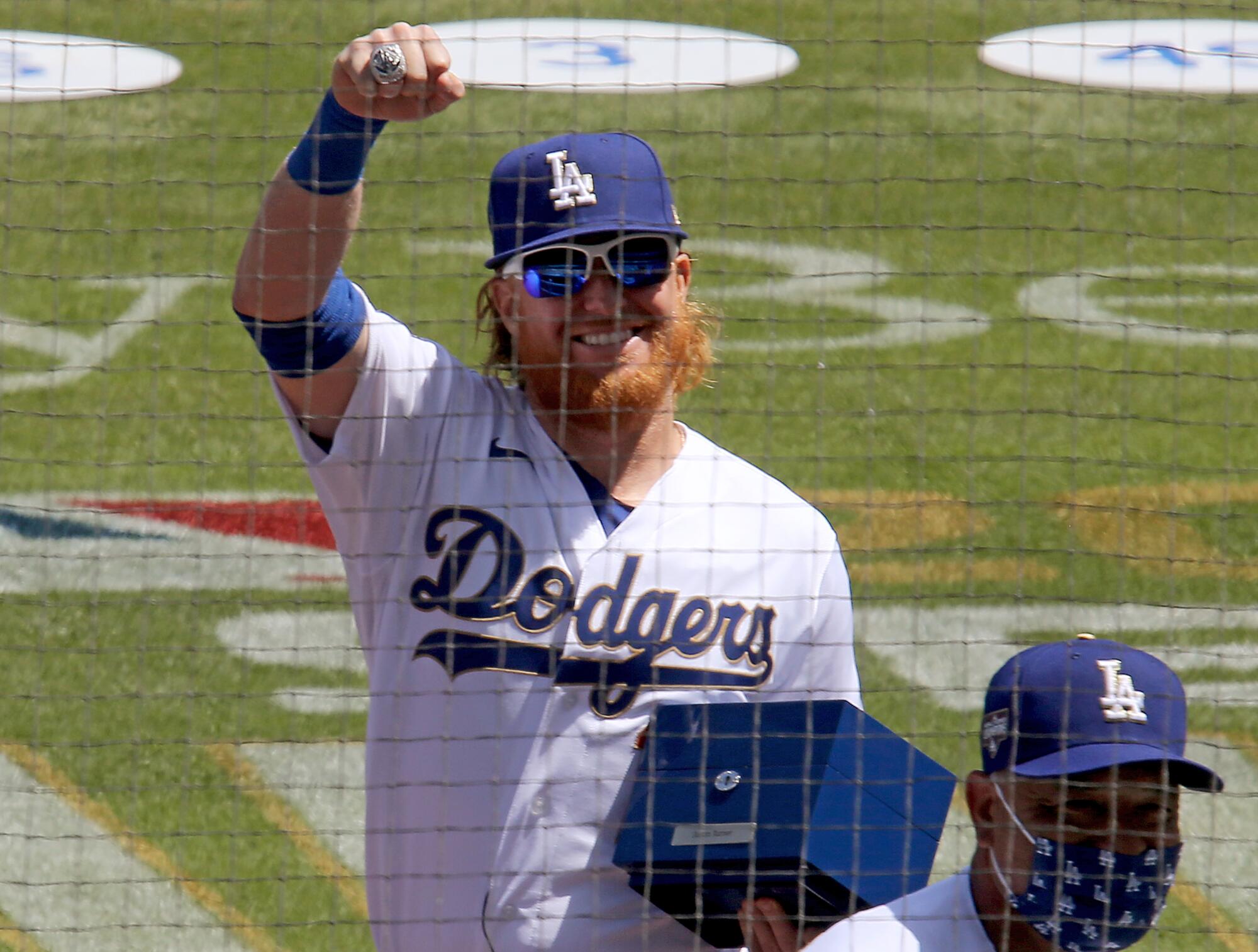 The Dodgers' Justin Turner celebrates after getting his championship ring during a ceremony before the home opener.