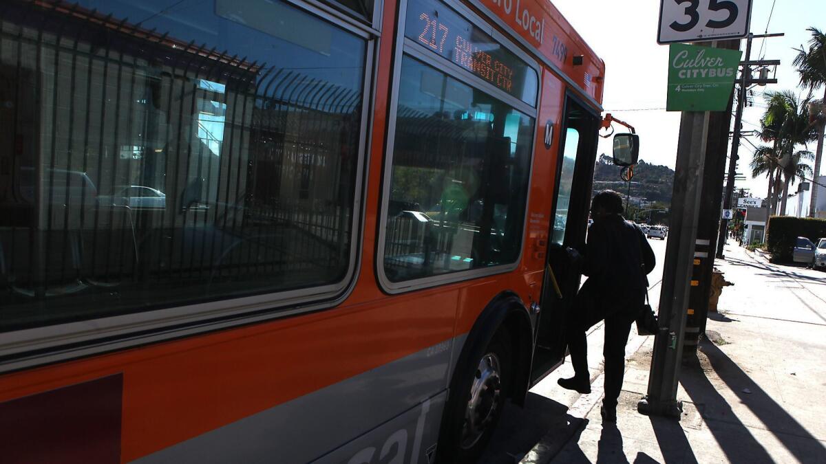 Senate Bill 827 would affect much of the city, in large part because it encourages four- to eight-story residential buildings near bus stops. Above, a passenger boards the Metro 217 bus on La Cienega Boulevard.