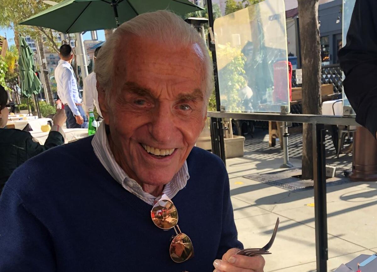 Jerry Douglas smiles while sitting at a sidewalk table in 2020