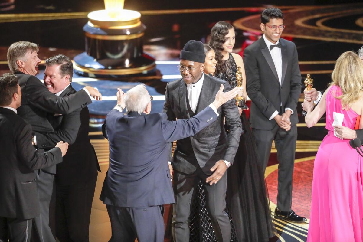 A group of people celebrating on stage at the Oscars.