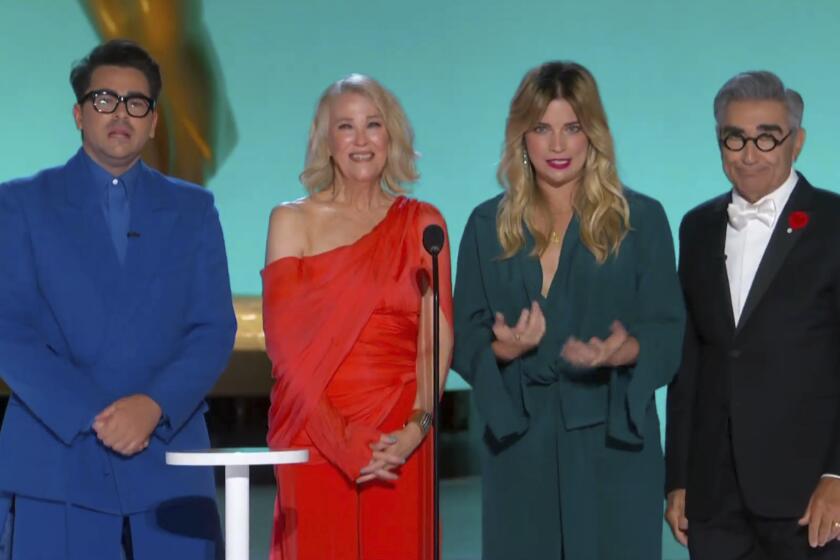 In this video grab issued Sunday, Sept. 19, 2021, by the Television Academy, Dan Levy, Catherine O'Hara, Annie Murphy and Eugene Levy present the award for outstanding writing for a comedy series during the Primetime Emmy Awards. (Television Academy via AP)