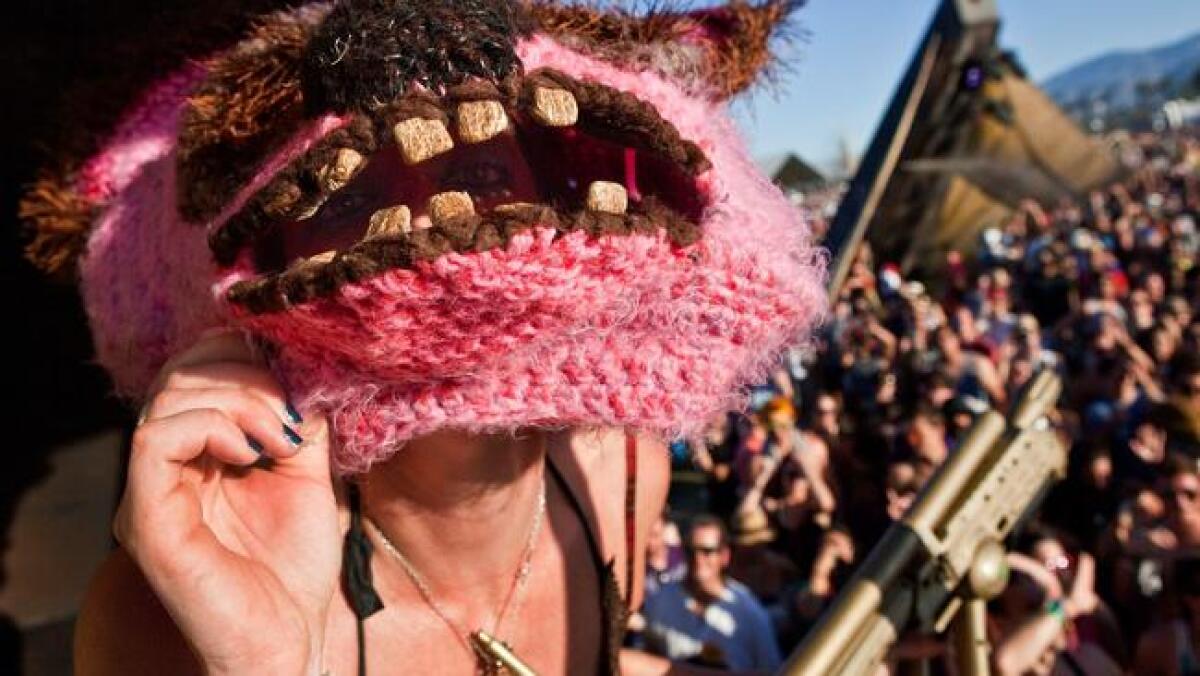 Sara Rose peeks through her bear mask while dancing on stage in the Do LaB at a recent Coachella.