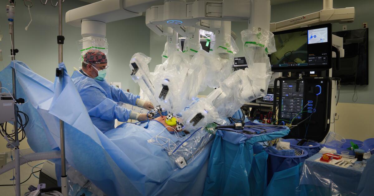 San Diego, CA - May 13: Lead Surgical Assistant, Carl Petty attaches one of the Da Vinci 5 instruments during surgery using the Da Vinci 5 robotics at Sharp Memorial Hospital on Monday, May 13, 2024 in San Diego, CA. (Nelvin C. Cepeda / The San Diego Union-Tribune)