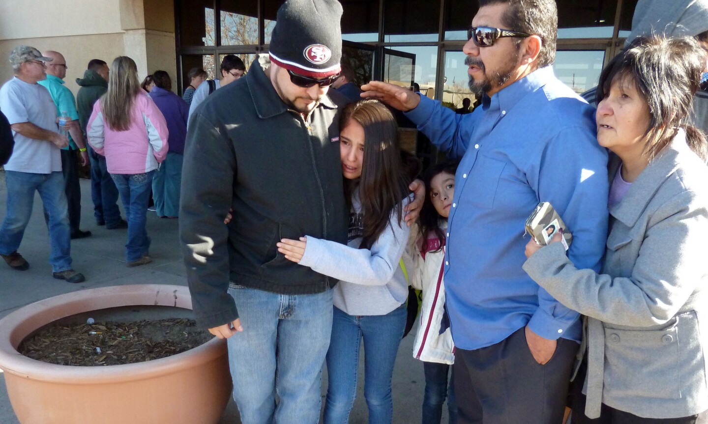 Parents converge on a mall to collect their children after a shooting Tuesday at Berrendo Middle School in Roswell, N.M.