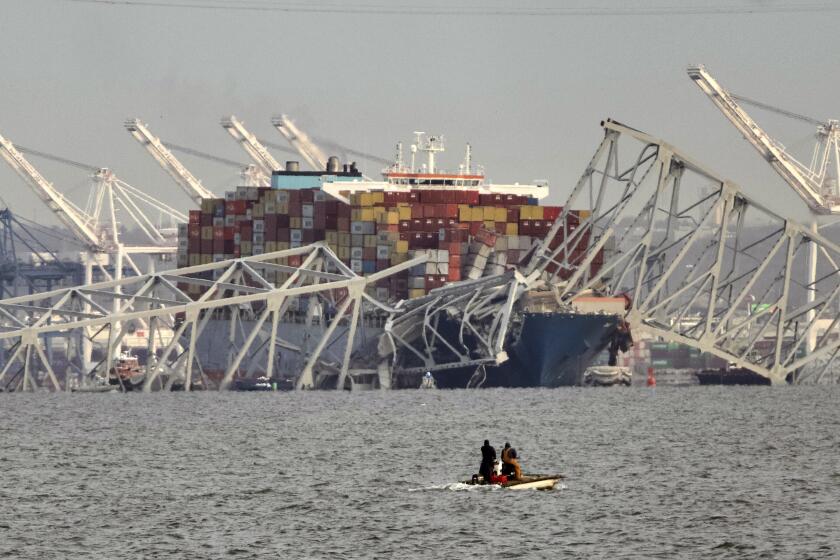 Parts of the Francis Scott Key Bridge remain after a container ship collided with one of the bridge’s supports, Tuesday, March 26, 2024 in Baltimore. The major bridge in Baltimore snapped and collapsed after a container ship rammed into it early Tuesday, and several vehicles fell into the river below. Rescuers were searching for multiple people in the water. (Kaitlin Newman/The Baltimore Banner via AP)