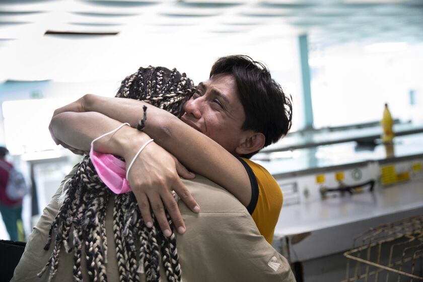 Ceidy Zethare, 22, embraces Emy Abrego, 34, after learning through a voice message that she will be allowed to enter the United States through a special program for particularly vulnerable migrants on Tuesday, May 17, 2022 in Tijuana, Baja California. The two have been living at Jardin de las Mariposas, a shelter for LGBTQ migrants and asylum seekers. Zethare came to the shelter several months ago and is currently transitioning and hopes to seek asylum in the United States.