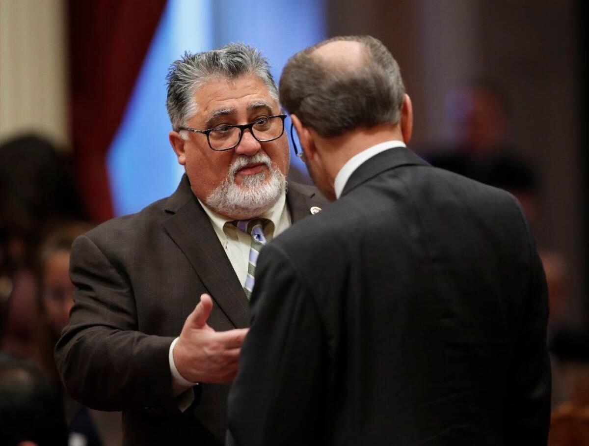 State Sen. Anthony Portantino (D-La Cañada Flintridge), left, talks with Sen. Jerry Hill (D-San Mateo) during the Senate session at the Capitol on Thursday.