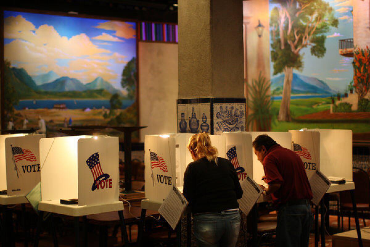 People vote at a polling place inside El Gallo restaurant in El Mercado de Los Angeles, a Mexico-style marketplace in the heavily Latino East L.A. area, during the presidential election.