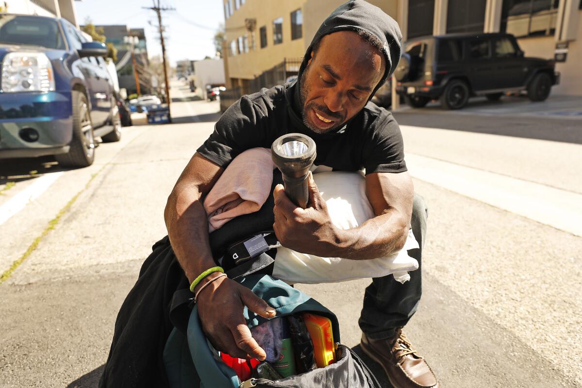 Jason Antoine Logan shows his flashlight used to see at night.