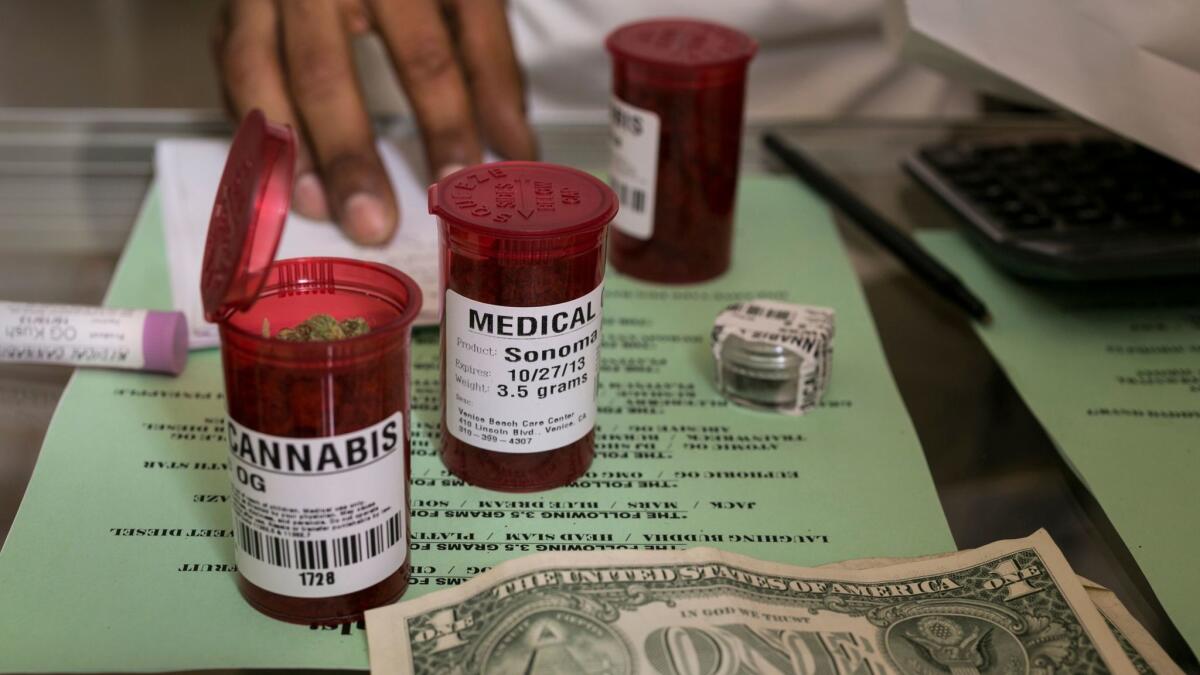 Medical marijuana prescription vials are filled at a medical marijuana dispensary in Venice on May 14, 2013.