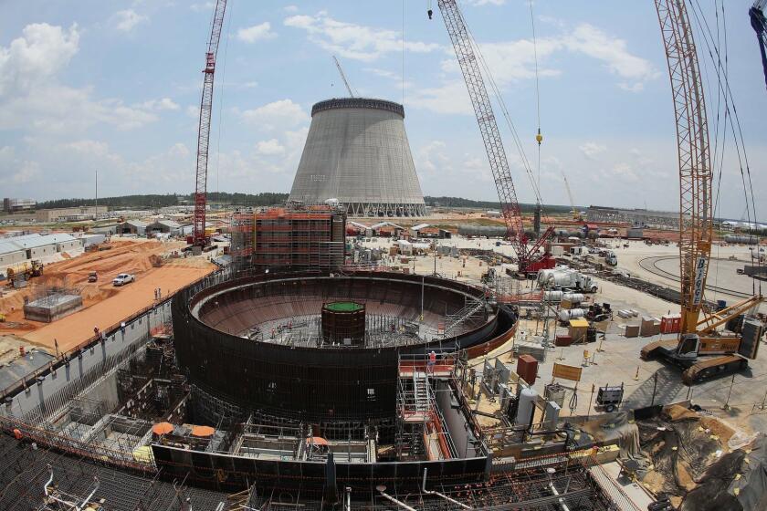 FILE- This June 13, 2014, file photo, shows construction on a new nuclear reactor at Plant Vogtle power plant in Waynesboro, Ga. Regulators say there's a "high probability" the nuclear plant under construction will see a delay longer than the three years already disclosed by its owners. (AP Photo/John Bazemore, File)