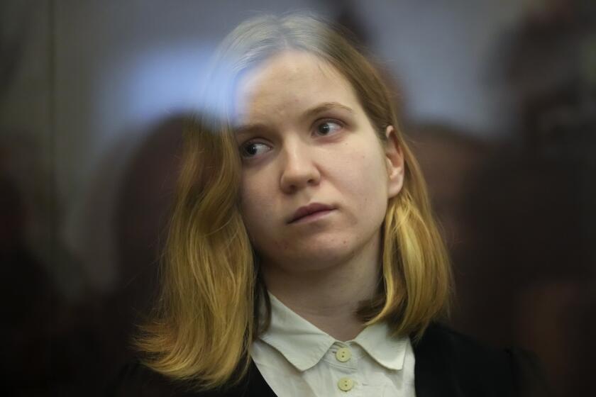 Darya Trepova, a suspect in a bombing that killed a well-known Russian military blogger, stands in a glass cage as she attends a court hearing in the 1st Western District Military Court, in St. Petersburg, Russia, Wednesday, Nov. 15, 2023. A military court in St Petersburg starts a trial against a 26-year-old woman Darya Trepova who is charged with terrorism after an attack at a St. Petersburg cafe that killed Russian military blogger Vladlen Tatarsky. (AP Photo/Dmitri Lovetsky)