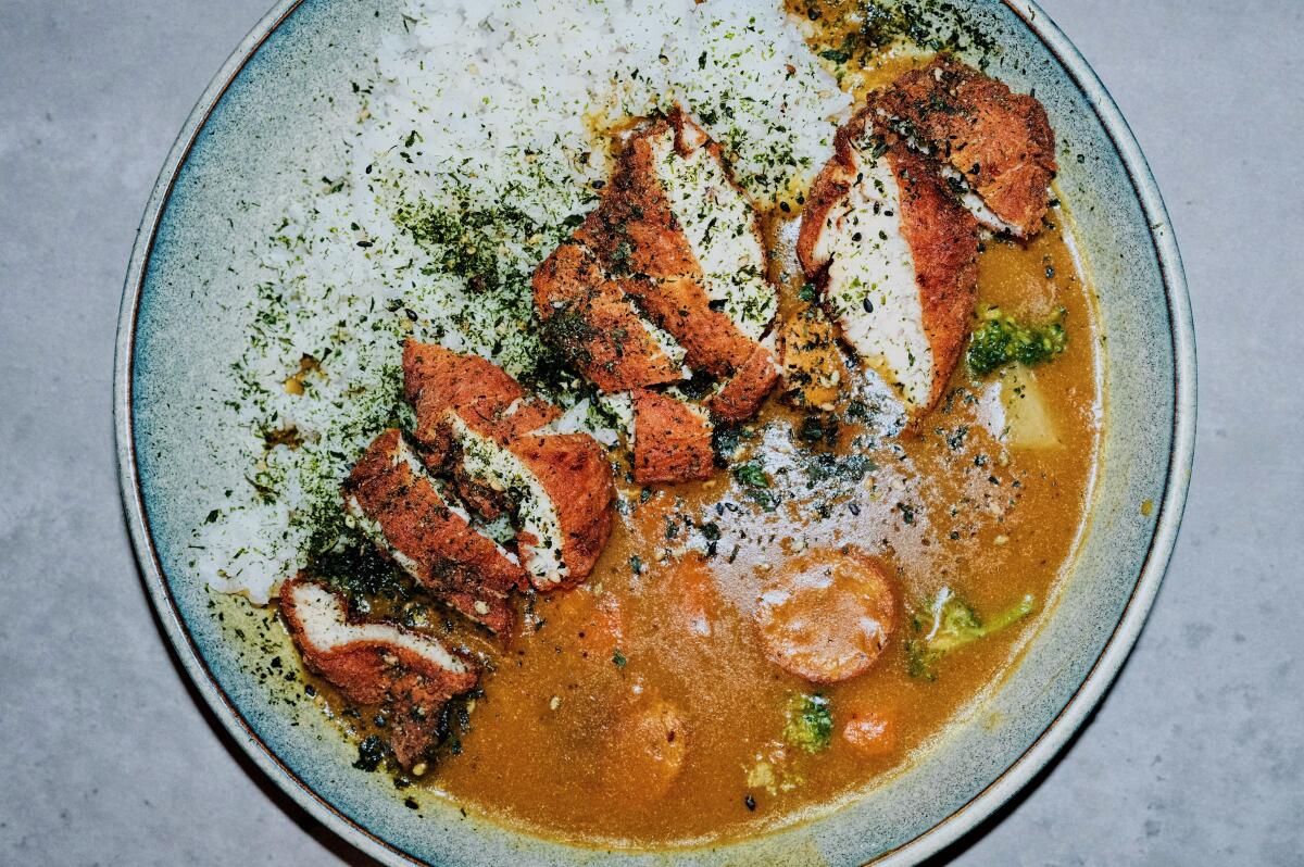 An overhead view of a bowl of Japanese curry with white rice and fried chicken at Wax on Hi-Fi in downtown Los Angeles