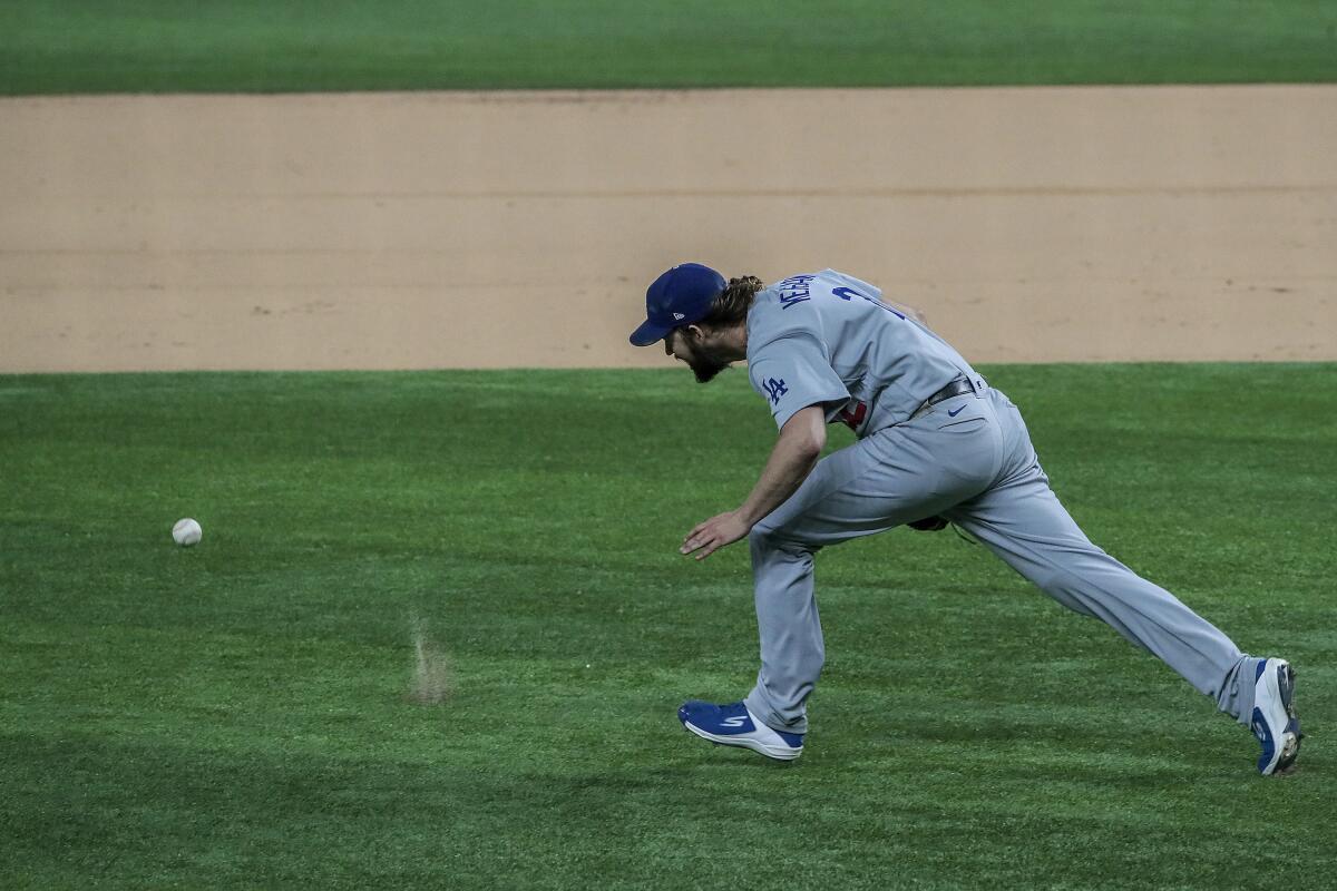 Dodgers starter Clayton Kershaw chases after a grounder hit by Atlanta's Ronald Acuna Jr.