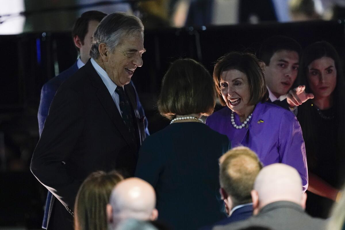 House Speaker Nancy Pelosi stands with her husband, Paul Pelosi, at an event.