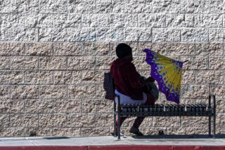 Covina, CA, Wednesday, October 2, 2024 -A person beats the heat by sitting in a shaded bus stop along Azusa Ave. (Robert Gauthier/Los Angeles Times)