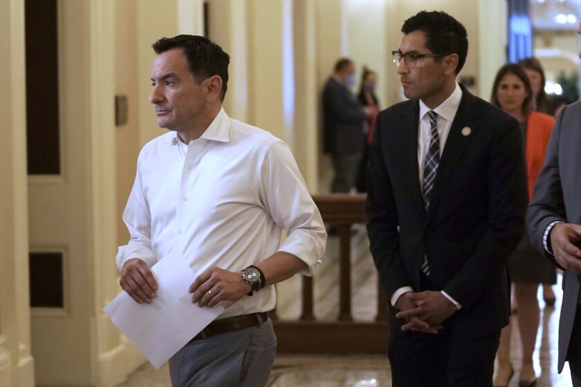 Assembly Speaker Anthony Rendon, left, of Lakewood, and Assemblyman Robert Rivas, D-Hollister, walk to a meeting of the Democratic caucus at the Capitol in Sacramento, Calif., Tuesday, May 31, 2022. After a caucus that lasted more than five hours, Rendon said that Rivas has the support of the majority of the Democratic caucus to be the next speaker. Rivas said Rendon should remain as speaker for the remainder of the legislative session. (AP Photo/Rich Pedroncelli)