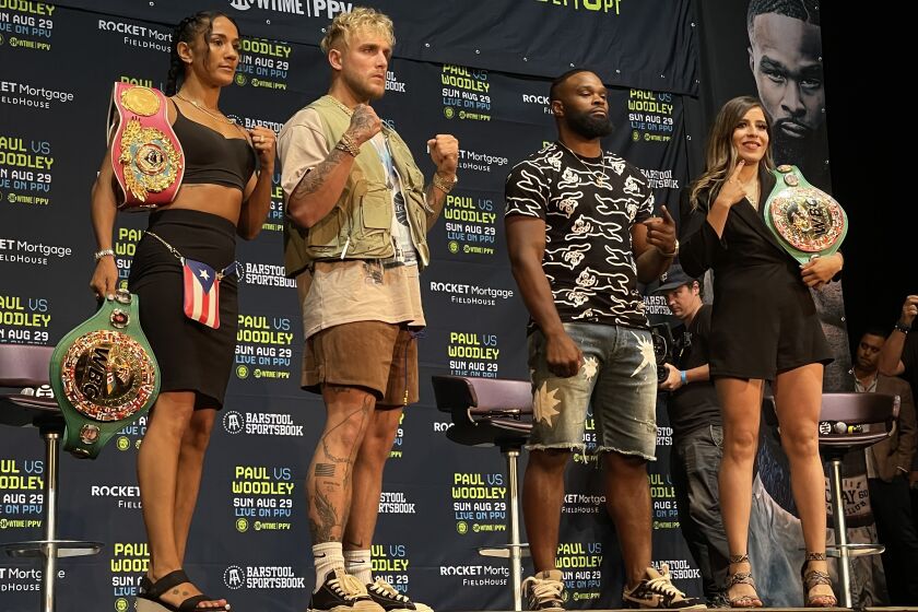 Amanda Serrano, Jake Paul, Tyron Woodley and Yamileth Mercado stand on the podium at The Novo after their press conference Tuesday, July 13, 2021.
