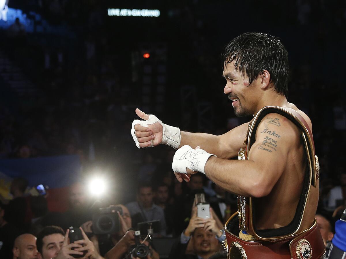 Manny Pacquiao celebrates after defeating Timothy Bradley in the WBO welterweight title boxing bout on April 9, 2016, in Las Vegas.