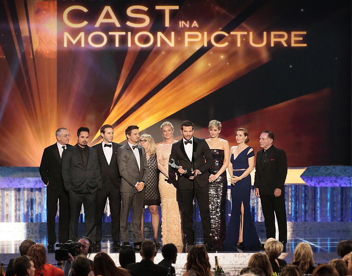 The cast of "American Hustle" wins the award for motion picture. Bradley Cooper gives his praises for the film's director David O. Russell.
