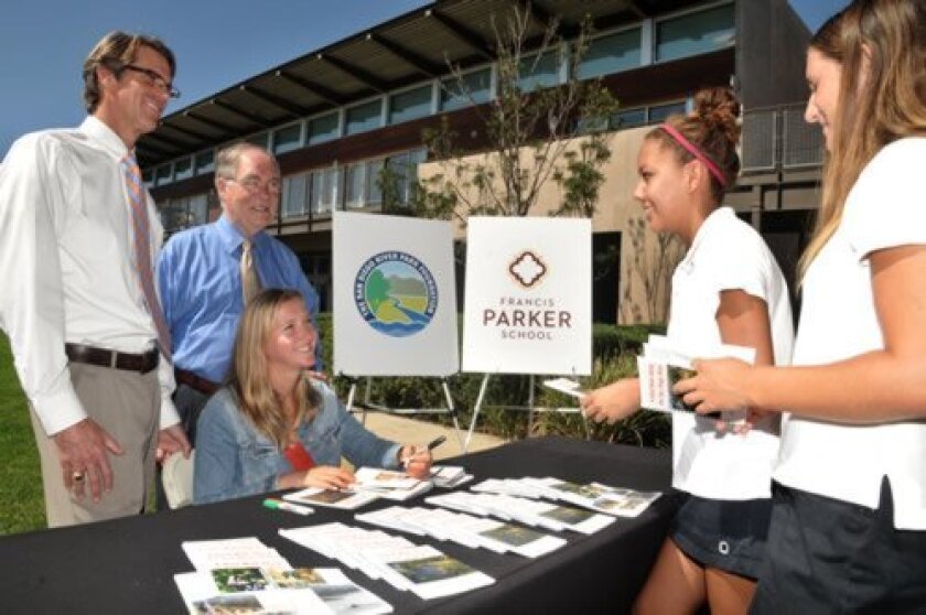 Head of School Kevin Yaley (left) and San Diego River Park Foundation Trustee Jim Dawe observe as Marly Isler signs her nature guide booklets for Class of 2017 Francis Parker School students Katherine Dews and Marly’s sister Megan Isler. Courtesy