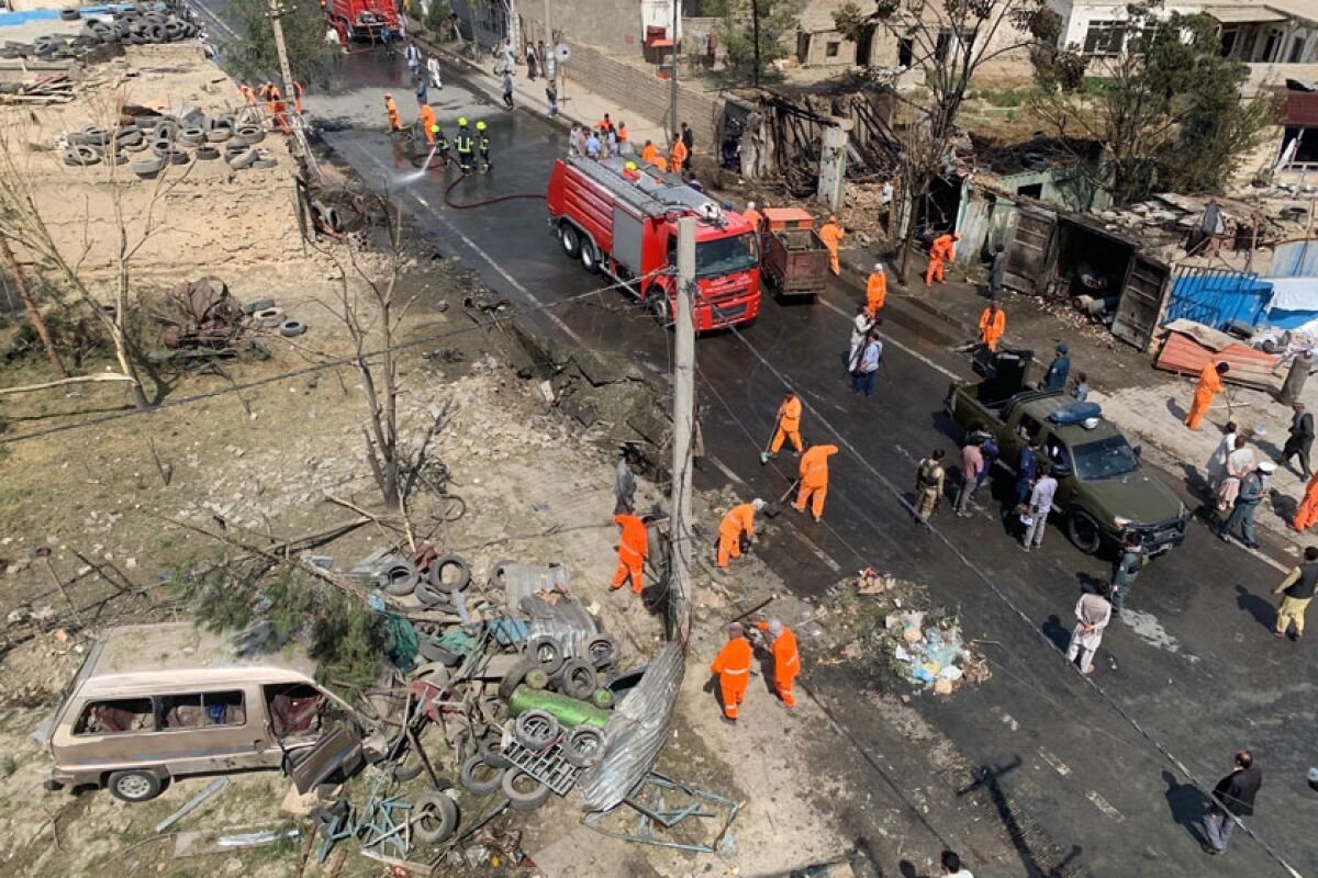 Workers clean the site of an explosion in Kabul, Afghanistan, on Wednesday.