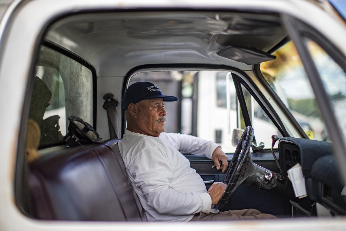 Jose Garcia, 63, of Long Beach, waits in the parking lot of a Home Depot for work as a day laborer.